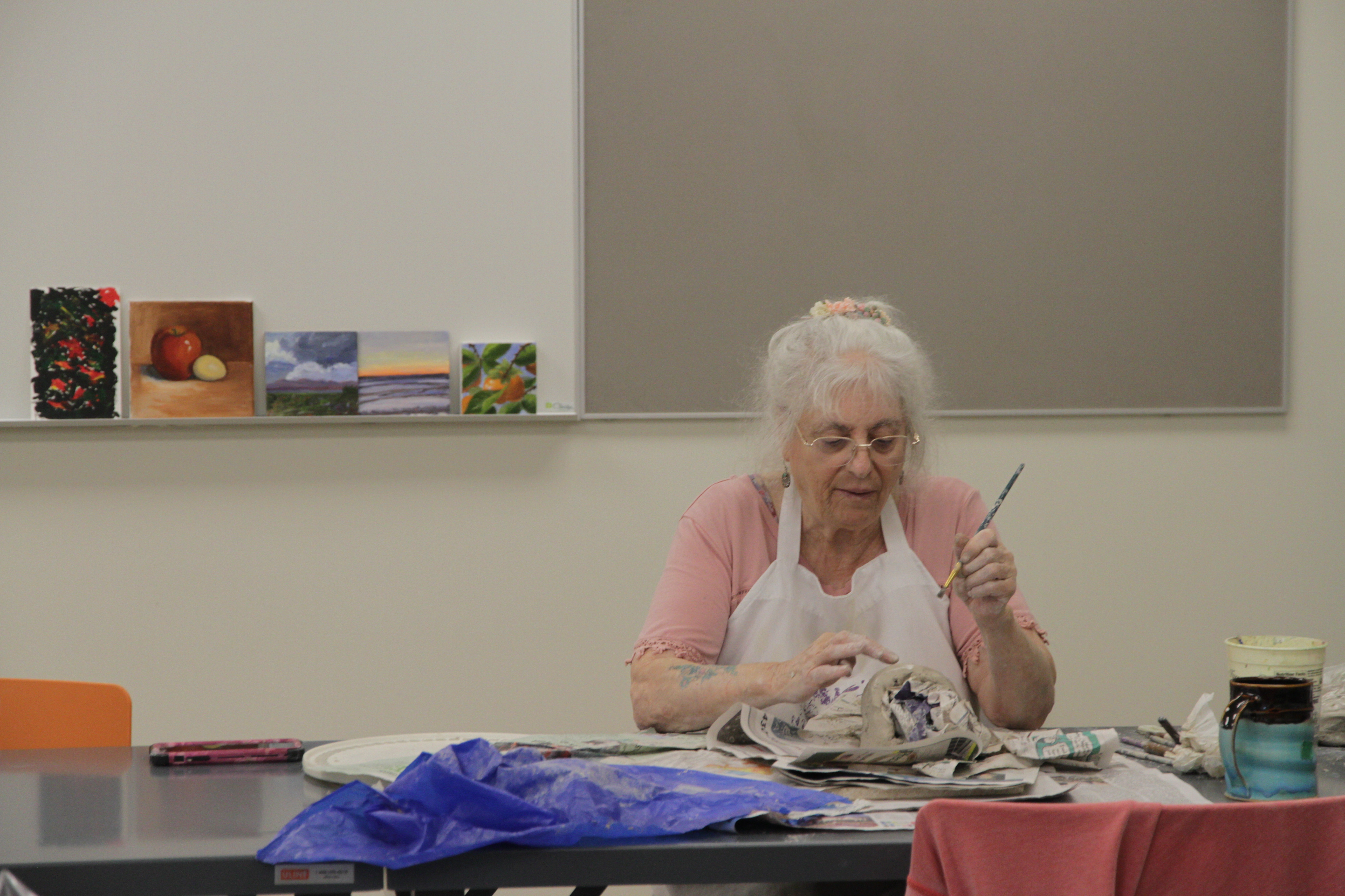 Older adults doing pottery