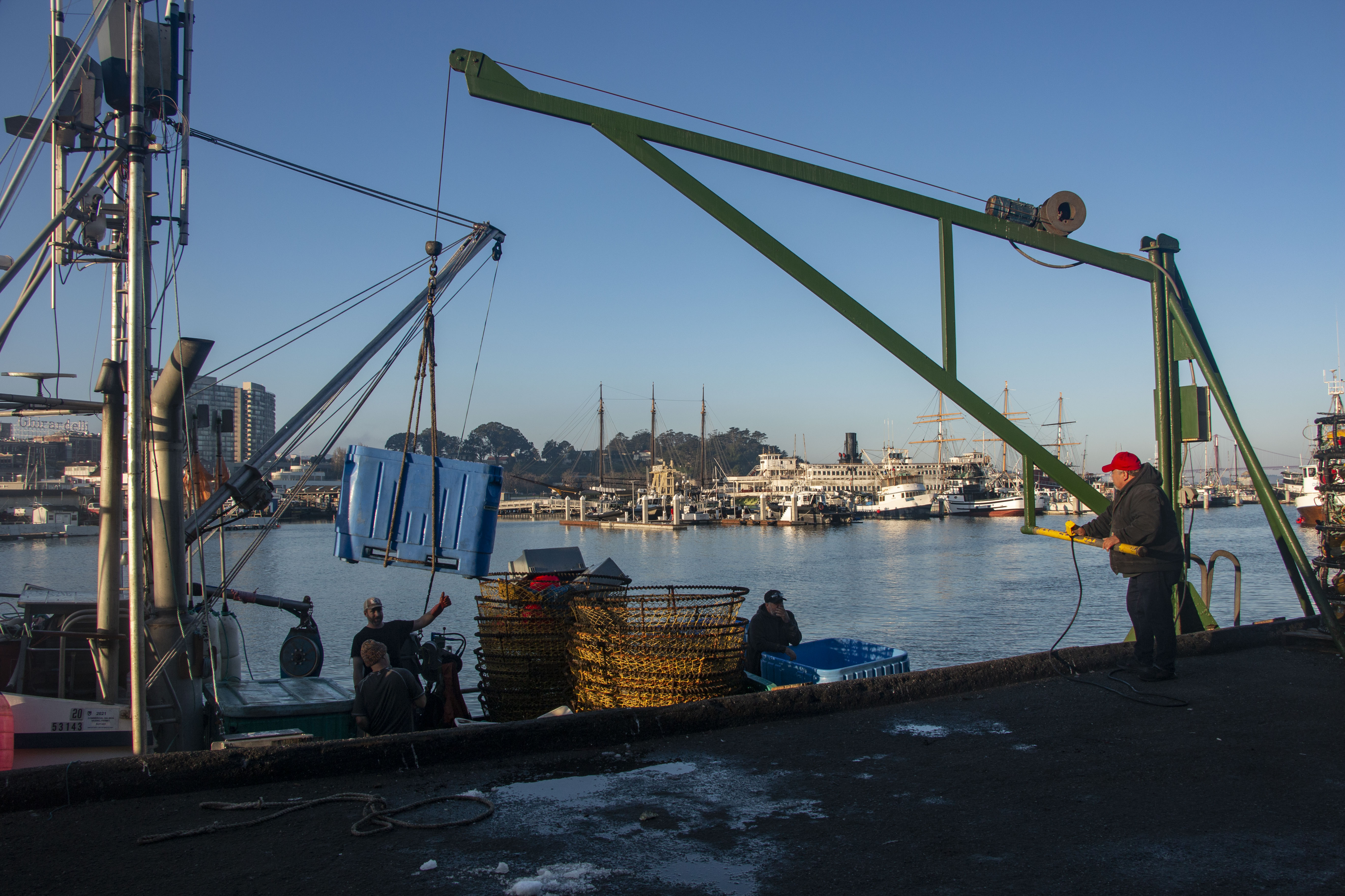 Larry Collins (in a red hat) was helping load ice to a ship.